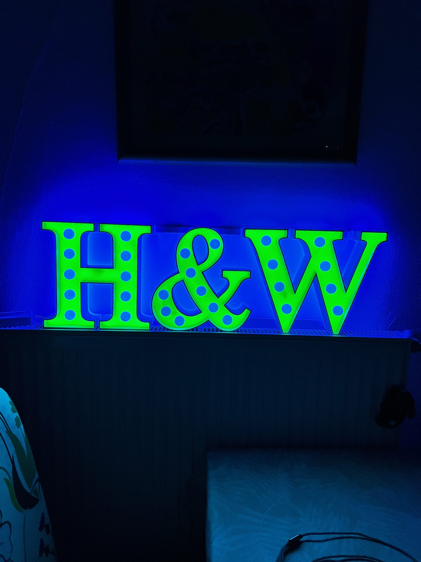 H&W sign with a blue halo from the RGB LED strip