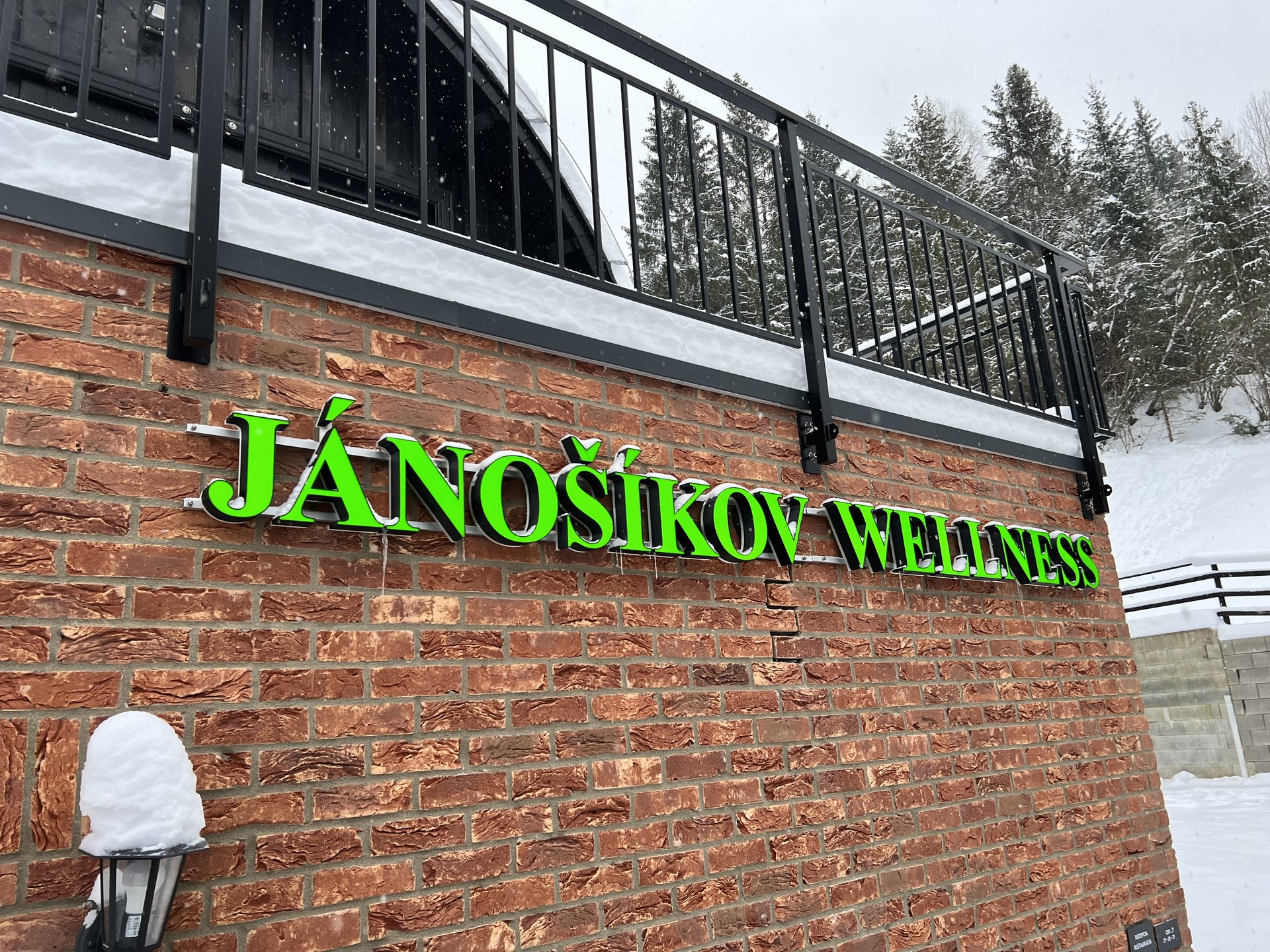 Jánošíkov Wellness channel letters on a brick wall in winter