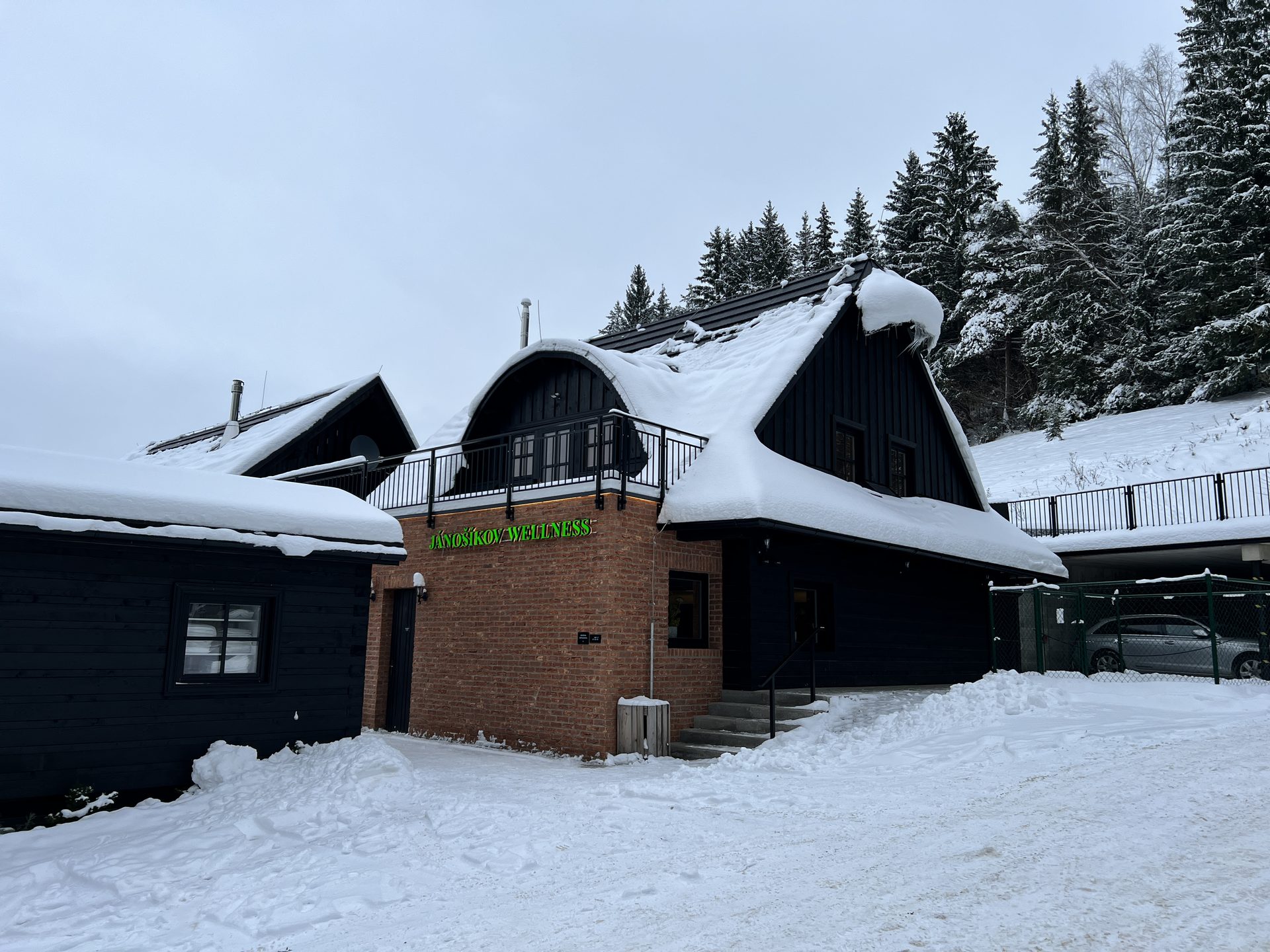Jánoíkov Wellness resort in winter with the green sign on the brick wall